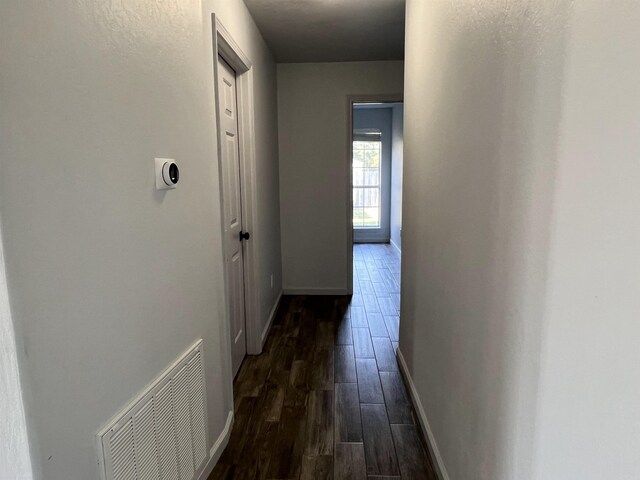 hall with dark wood-type flooring