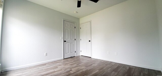 spare room with ceiling fan and hardwood / wood-style flooring