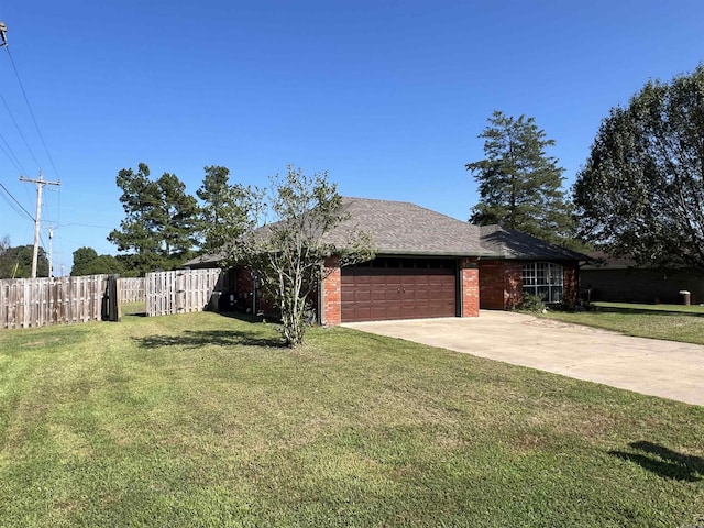 view of front of property featuring a garage and a front lawn