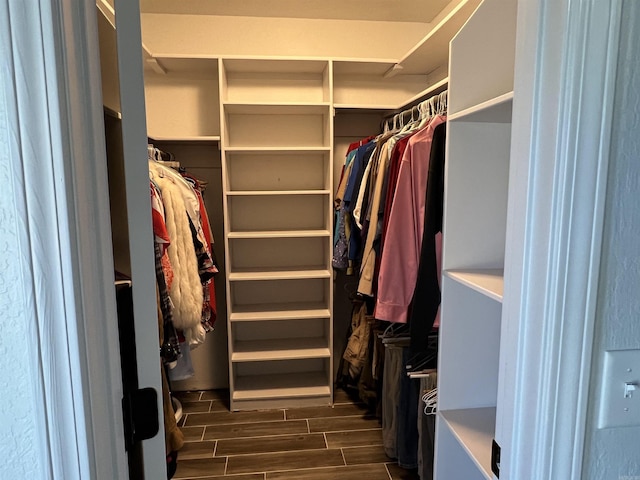 walk in closet with wood tiled floor