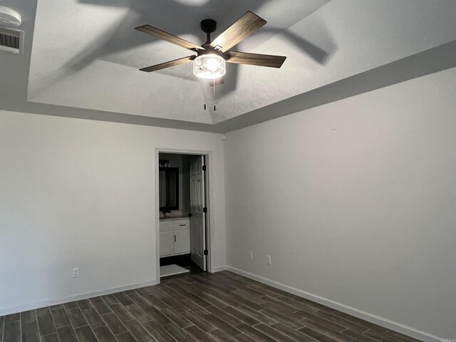 unfurnished room featuring ceiling fan and dark wood-type flooring