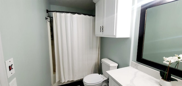 bathroom featuring toilet, shower / tub combo, and vanity