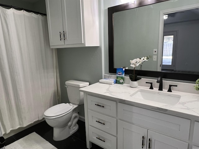 bathroom featuring toilet, curtained shower, and vanity