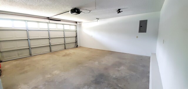 garage with a garage door opener and electric panel