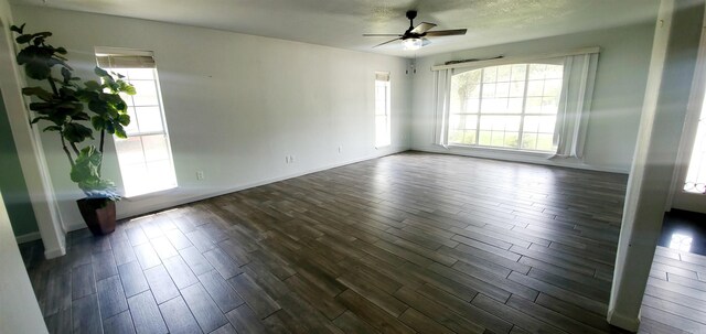 unfurnished room featuring ceiling fan and dark hardwood / wood-style flooring