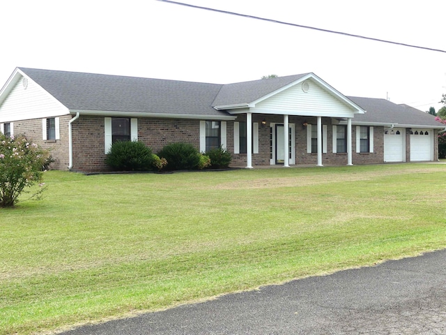 ranch-style house featuring a garage and a front lawn