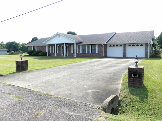 ranch-style home with a garage and a front lawn