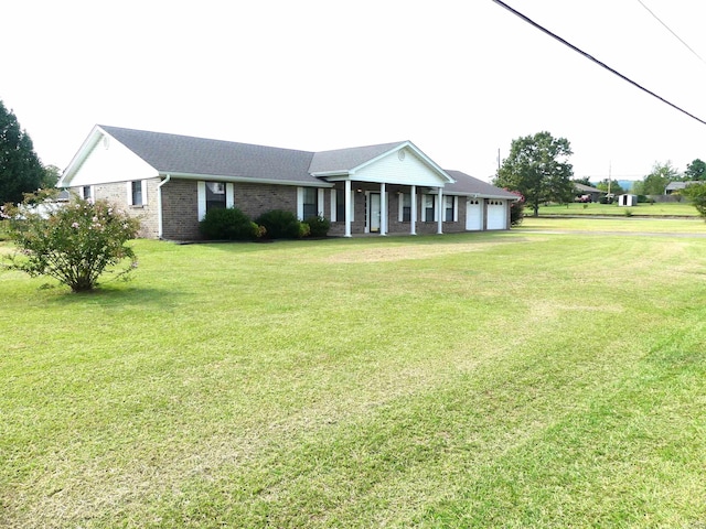 ranch-style home featuring a garage and a front yard