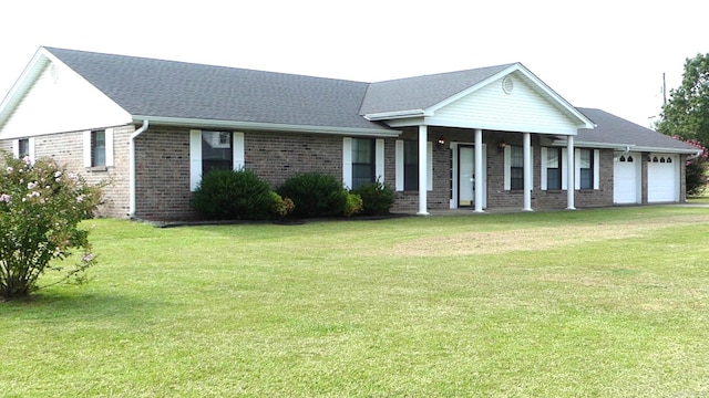 ranch-style home featuring a garage and a front lawn