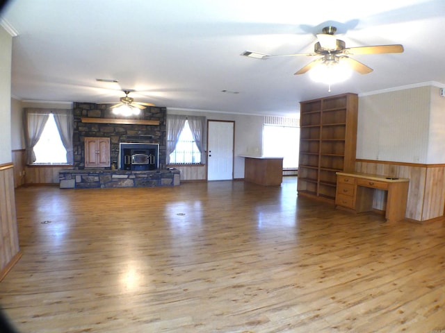 1105 Crescent Dr, Mena, AR 71953 - unfurnished living room with wood finished floors, crown molding, ceiling fan, a wainscoted wall, and wooden walls