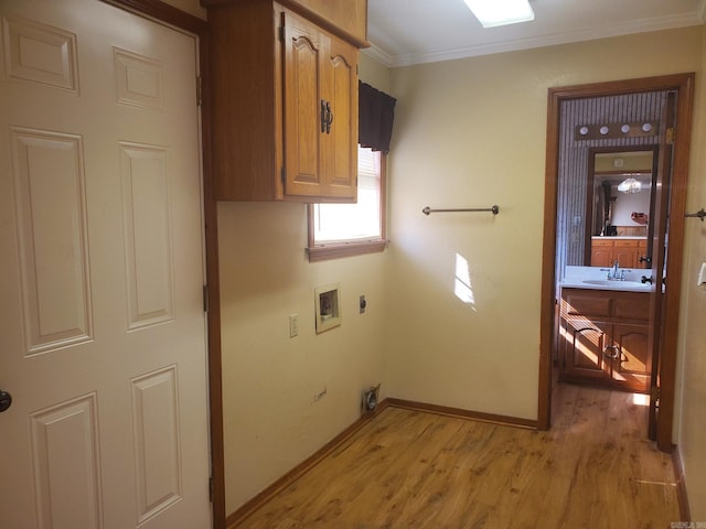 1105 Crescent Dr, Mena, AR 71953 - laundry area with cabinet space, light wood finished floors, hookup for a washing machine, ornamental molding, and electric dryer hookup