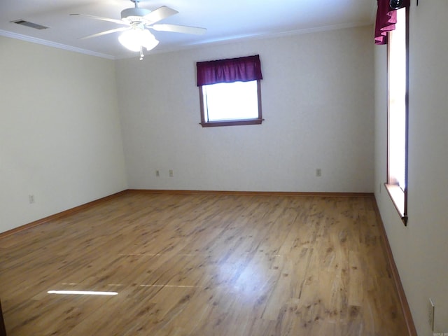 1105 Crescent Dr, Mena, AR 71953 - empty room featuring crown molding, wood finished floors, a ceiling fan, and baseboards