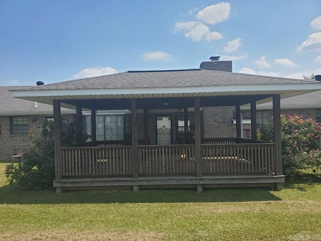 rear view of property featuring a yard