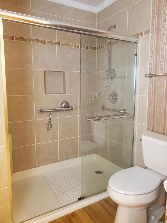 1105 Crescent Dr, Mena, AR 71953 - bathroom with a shower stall, toilet, and wood finished floors
