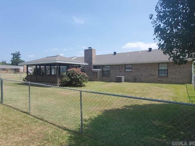 1105 Crescent Dr, Mena, AR 71953 - rear view of house featuring central air condition unit, a chimney, and brick siding