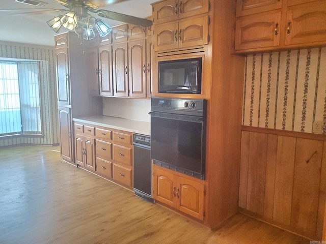 kitchen with ceiling fan, light hardwood / wood-style flooring, and black appliances