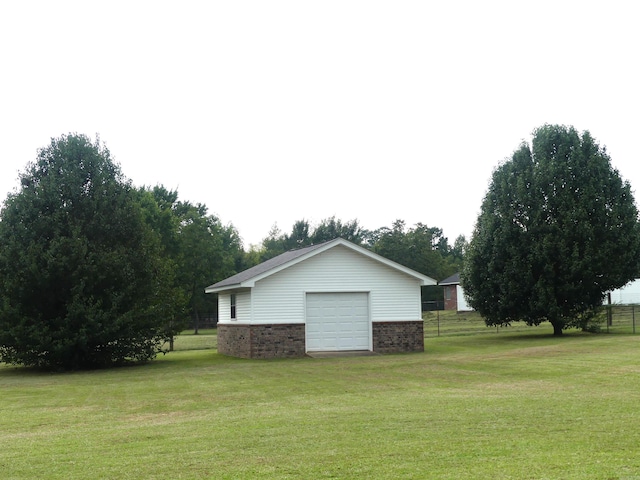 1105 Crescent Dr, Mena, AR 71953 - view of side of home featuring a garage, a yard, an outbuilding, and brick siding