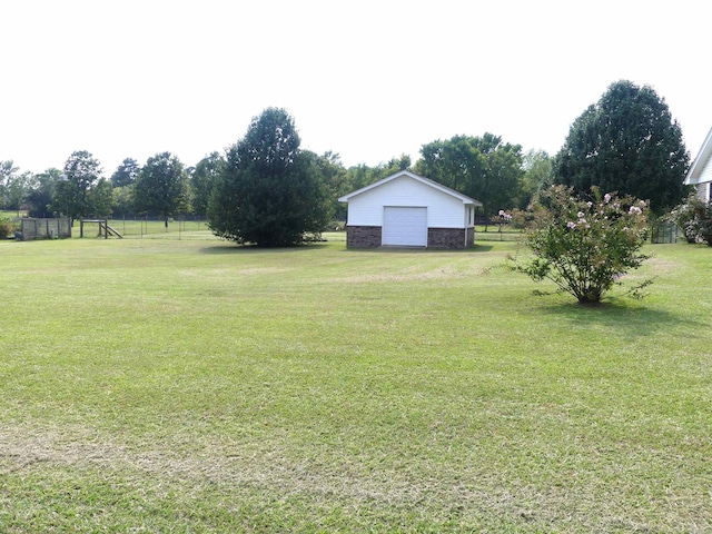 1105 Crescent Dr, Mena, AR 71953 - view of grassy yard with a garage and an outbuilding