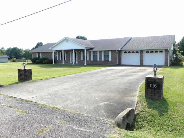 1105 Crescent Dr, Mena, AR 71953 - view of front of house with asphalt driveway, a garage, a front yard, and brick siding