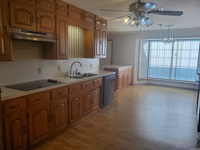 kitchen with light hardwood / wood-style flooring, decorative light fixtures, sink, black appliances, and ceiling fan