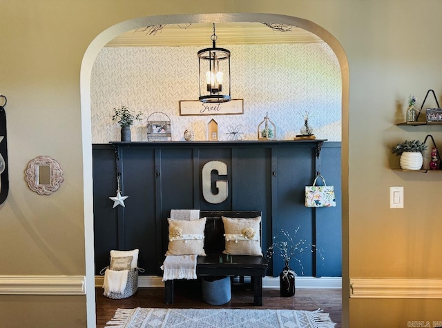 interior space featuring arched walkways, dark wood-style flooring, and baseboards