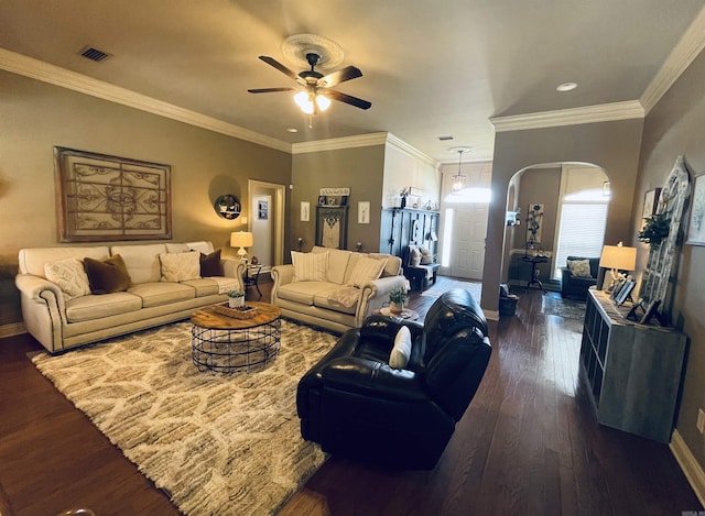 living room with dark wood-style floors, arched walkways, ornamental molding, and baseboards