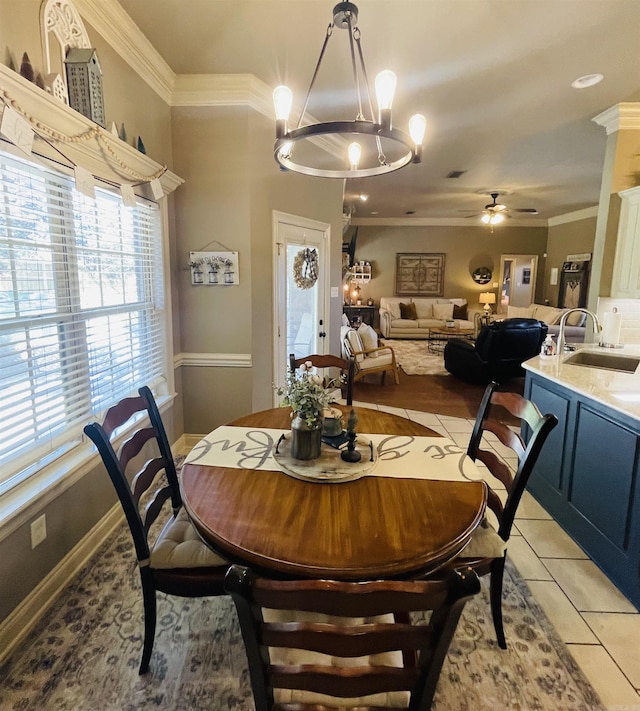 dining area featuring ornamental molding, light tile patterned flooring, baseboards, and a ceiling fan