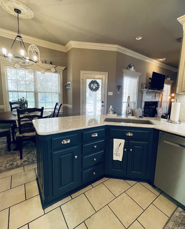 kitchen with blue cabinetry, stainless steel dishwasher, an inviting chandelier, a glass covered fireplace, and a sink