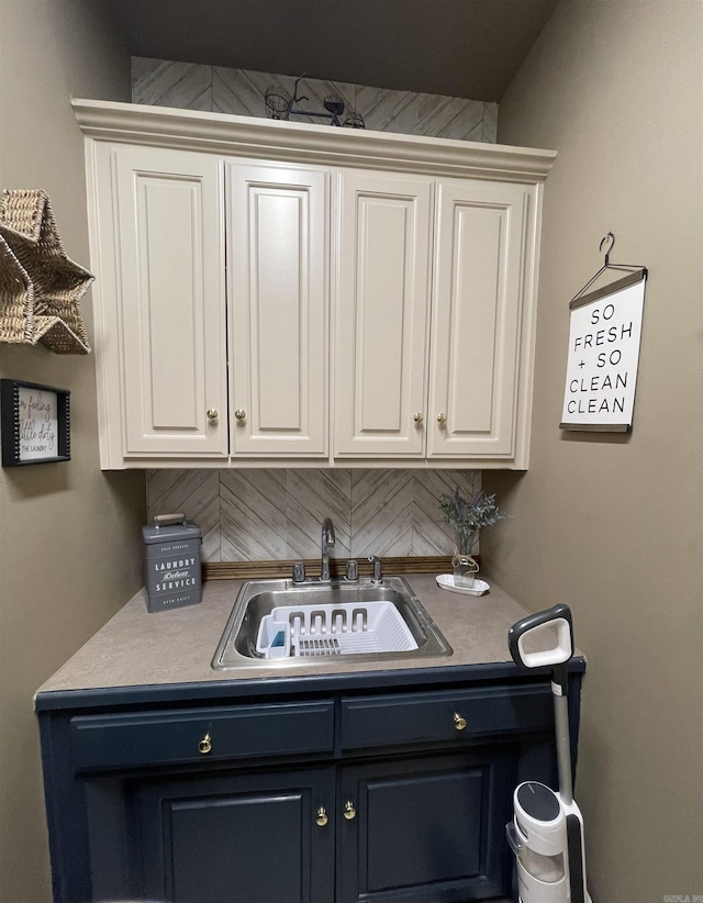 clothes washing area featuring a sink