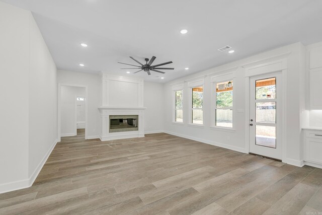 unfurnished living room featuring a fireplace, beamed ceiling, french doors, ceiling fan with notable chandelier, and dark hardwood / wood-style floors