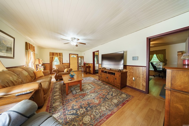 living room with a wealth of natural light, hardwood / wood-style floors, wood ceiling, and ceiling fan