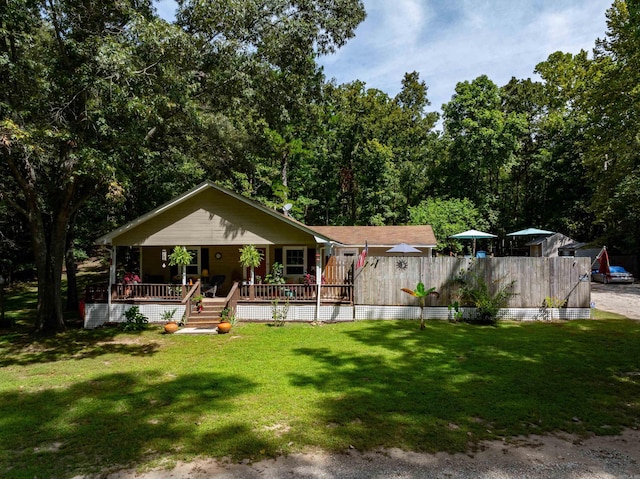 view of front of home featuring covered porch and a front yard