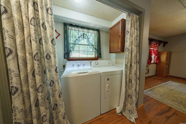 laundry room featuring a textured ceiling, dark hardwood / wood-style floors, and independent washer and dryer