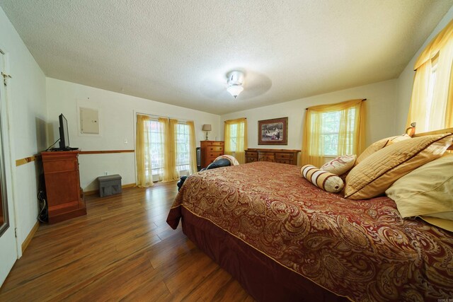 bedroom featuring dark wood-type flooring and a textured ceiling