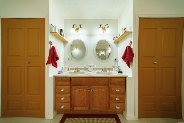 bathroom featuring a textured ceiling and vanity