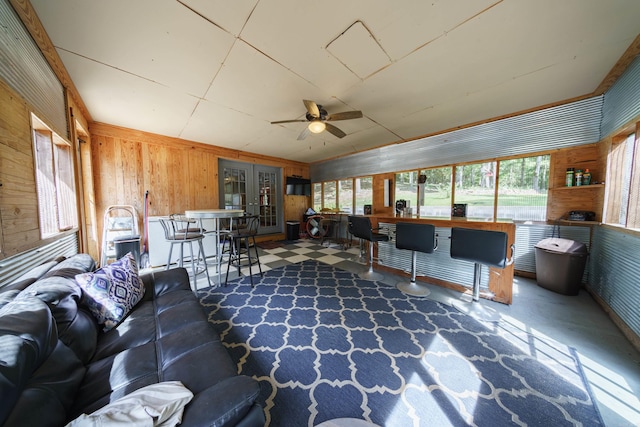 sunroom with a wealth of natural light, ceiling fan, and french doors