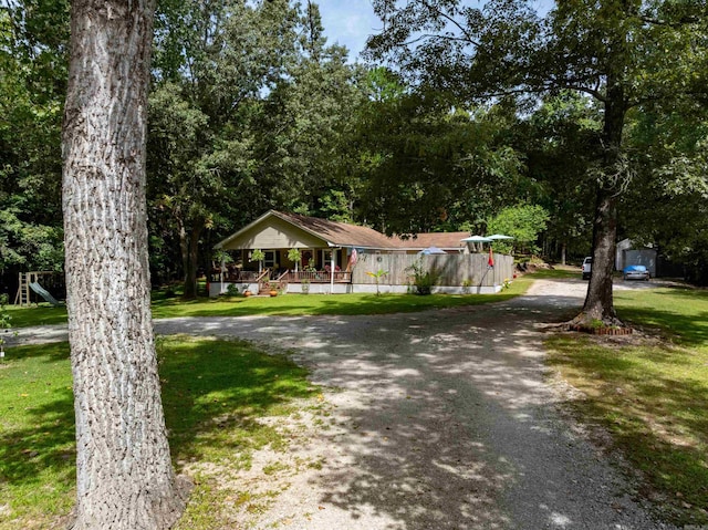 view of front of house featuring a front lawn and a playground