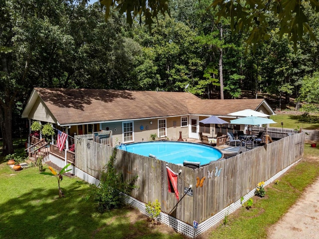 view of pool with a yard