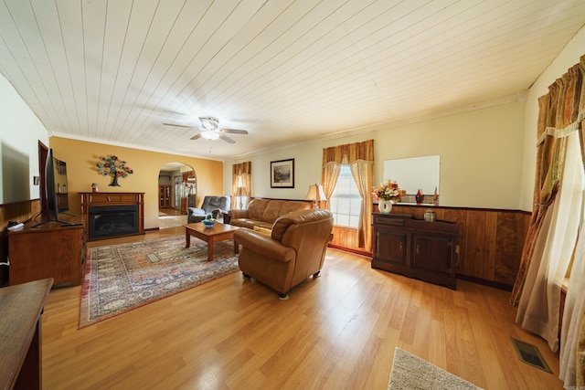 living room with light wood-type flooring, wooden ceiling, ceiling fan, and ornamental molding