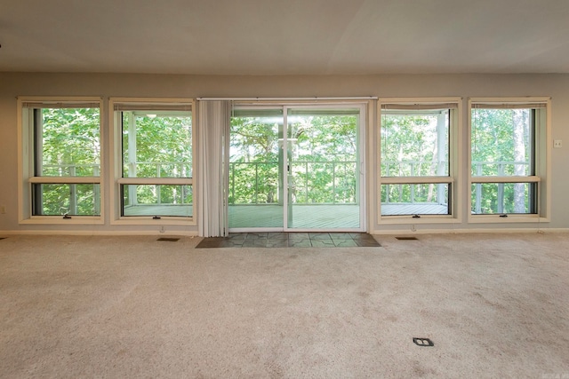 unfurnished living room featuring carpet flooring