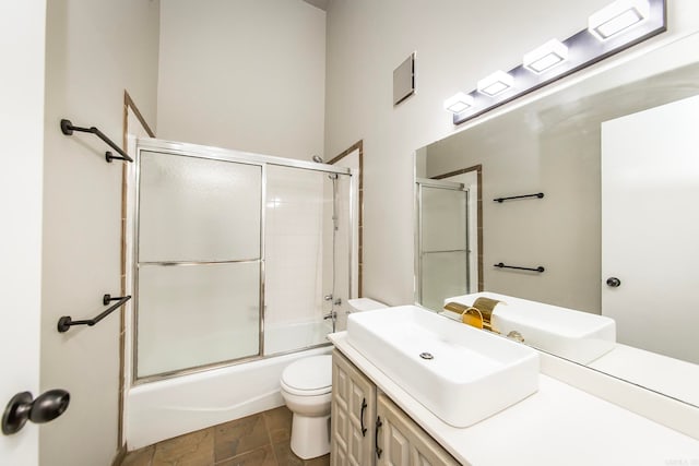 full bathroom with tile patterned flooring, combined bath / shower with glass door, toilet, and vanity