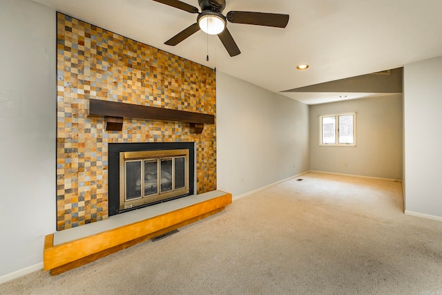 unfurnished living room featuring ceiling fan, carpet flooring, and a fireplace