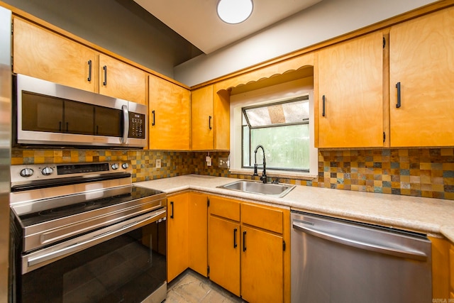 kitchen featuring sink, decorative backsplash, light tile patterned flooring, and stainless steel appliances