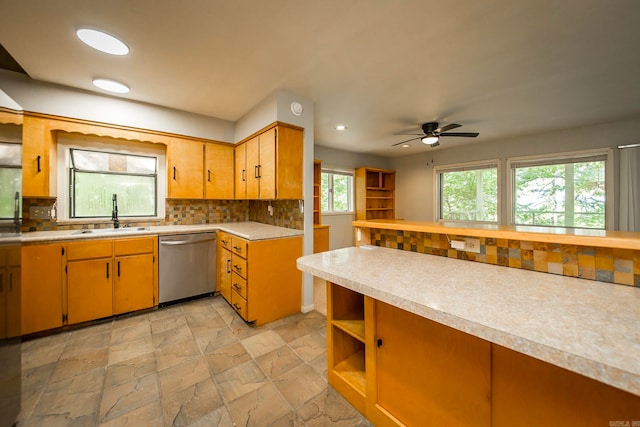 kitchen with ceiling fan, stainless steel dishwasher, backsplash, light tile patterned floors, and sink