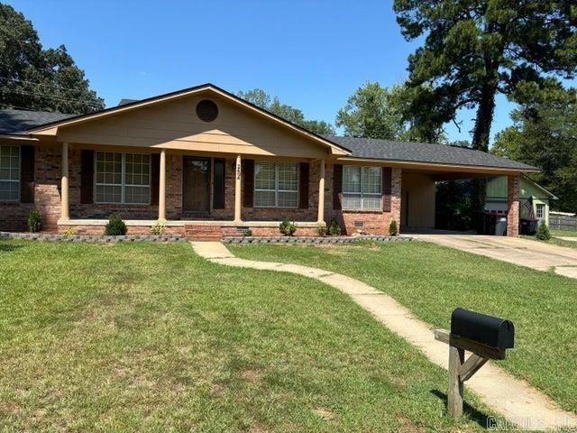 2404 W 3rd, Russellville, AR 72801 - ranch-style house with a carport, concrete driveway, brick siding, and a front lawn