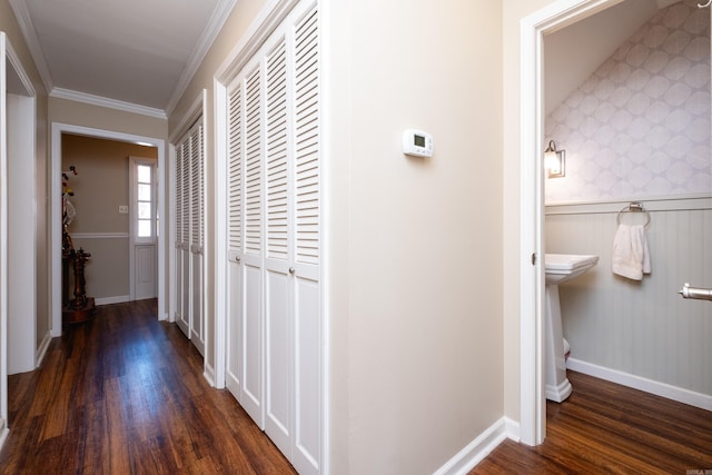 hall with dark hardwood / wood-style floors and crown molding