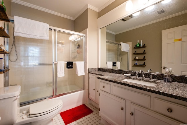 full bathroom with shower / bath combination with glass door, vanity, crown molding, tile patterned floors, and toilet