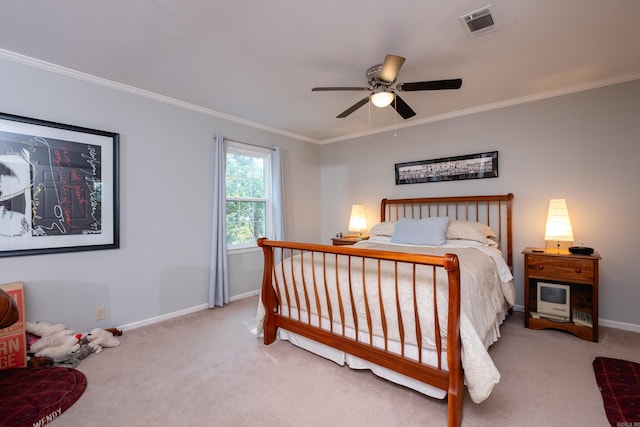 carpeted bedroom featuring ceiling fan and crown molding