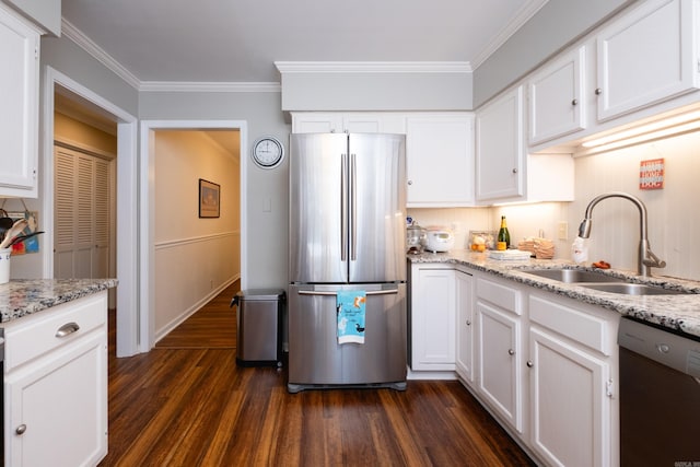 kitchen featuring sink, appliances with stainless steel finishes, dark hardwood / wood-style floors, and light stone countertops