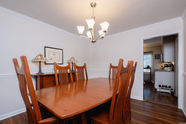 dining area featuring a notable chandelier, ornamental molding, and dark hardwood / wood-style floors